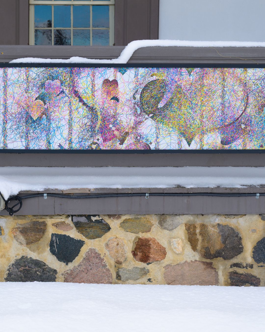Close up of one lightbox showing colourful art
